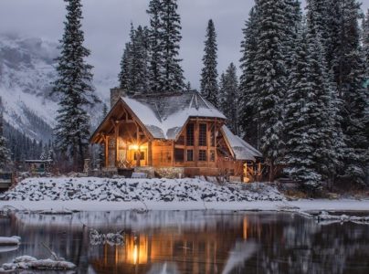 pictures of modern cottage surrounded by snow, trees and mountains